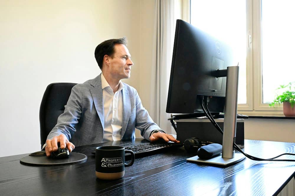 A man working at a desk and a computer