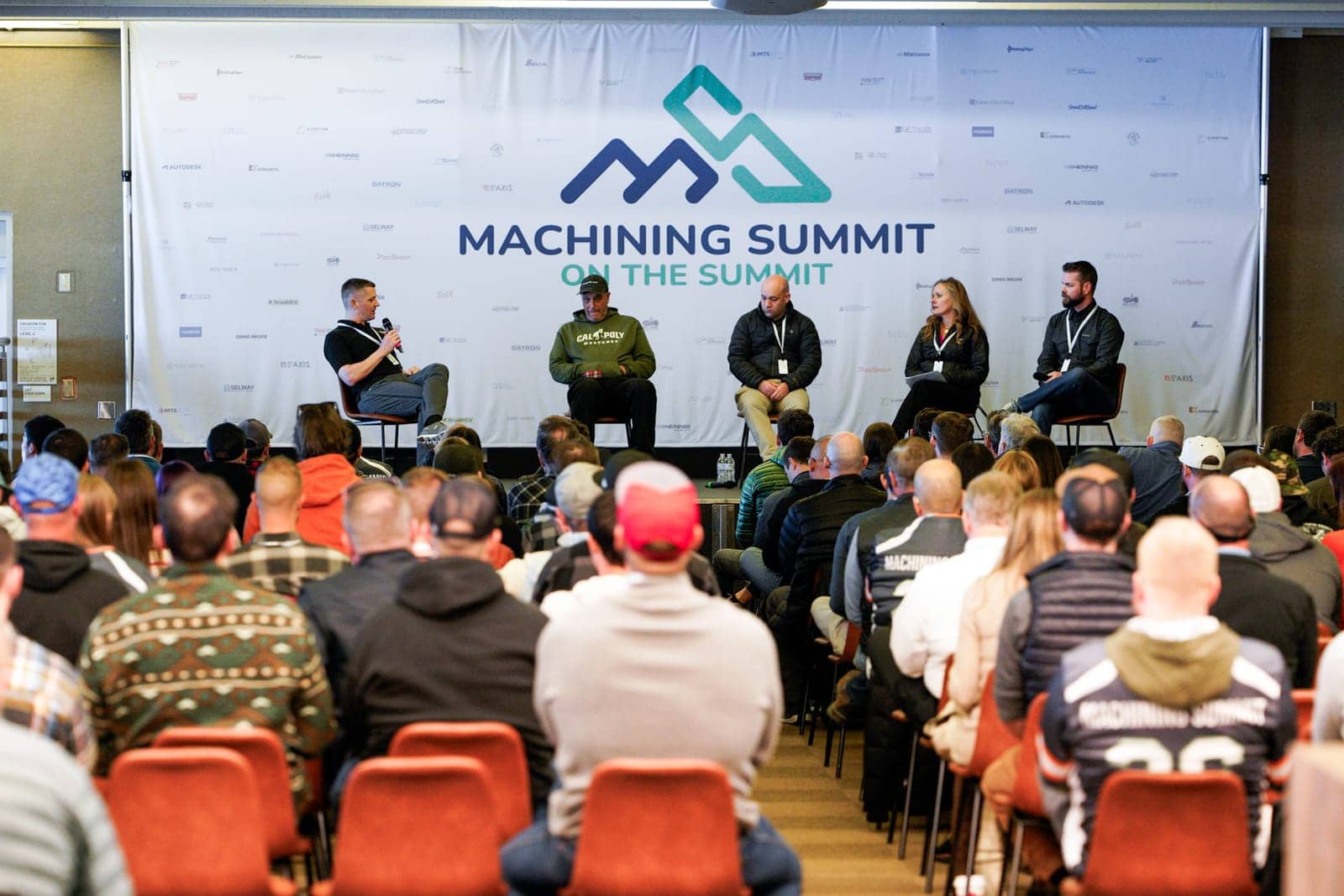 A panel in front of a full room