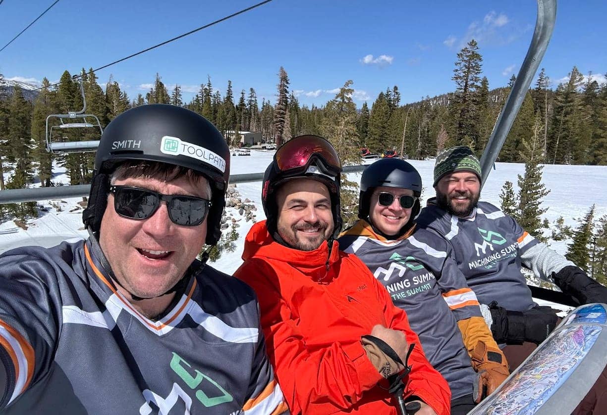 Attendees in conversation on a chairlift
